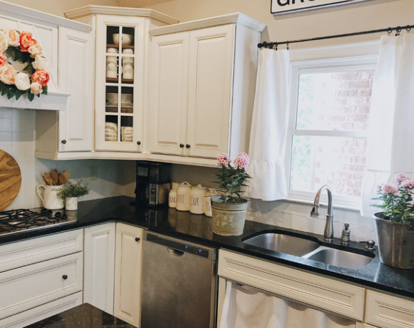Two custom made linen curtains hang above our kitchen sink and a custom made linen sink curtain below it. To read about how we painted our kitchen cabinets, you can head  here  for all the details.