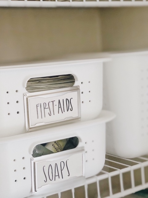 How To Create Organize Your Bathroom Closet, tips featured by top AL home blogger, She Gave It A Go | How to Organize a Bathroom Closet by popular Alabama lifestyle blog, She Gave It A Go: image of labeled white plastic bins. 