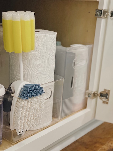 5 Easy and Super Practical Under Sink Organization Ideas for your Home featured by top AL home and lifestyle blogger, She Gave It A Go |Under Sink Organization by popular Alabama lifestyle blog, She Gave It A Go: image of paper towels and cleaning brushing in a acrylic bin. 