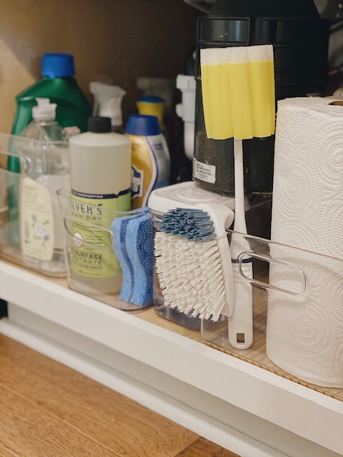 5 Easy and Super Practical Under Sink Organization Ideas for your Home featured by top AL home and lifestyle blogger, She Gave It A Go |Under Sink Organization by popular Alabama lifestyle blog, She Gave It A Go: image of cleaning supply and sponges in an acrylic bin. 
