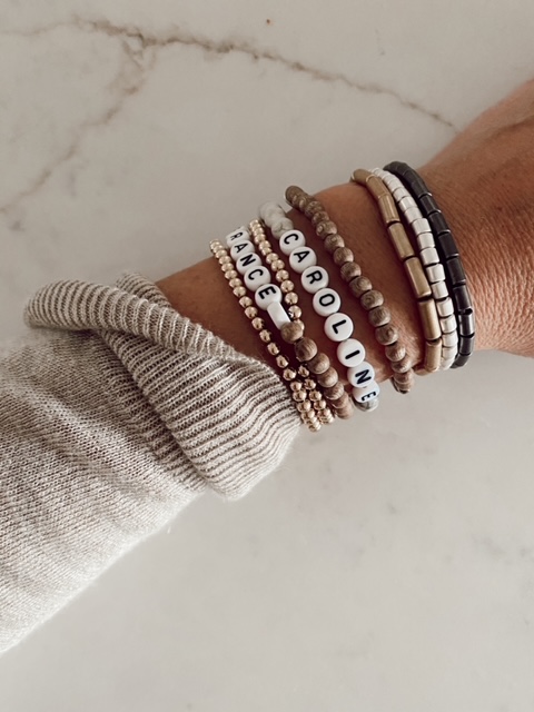 10 Uplifting Mother's Day Gifts featured by top AL lifestyle blogger, She Gave It A Go |Mother's Day Gifts by popular Alabama lifestyle blog, She Gave It A Go: image of a woman wearing bead name bracelets. 