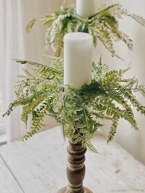 Cool DIY Summer Candle Rings, a Tutorial featured by top AL home blogger, She Gave It A Go | Candle Rings by popular Alabama DIY blog, She Gave It A Go: image of two while pillar candles on wooden candle pillars decorated with faux green candle rings. 