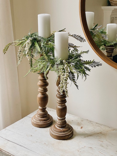 Cool DIY Summer Candle Rings, a Tutorial featured by top AL home blogger, She Gave It A Go |Candle Rings by popular Alabama DIY blog, She Gave It A Go: image of two while pillar candles on wooden candle pillars decorated with faux green candle rings. 