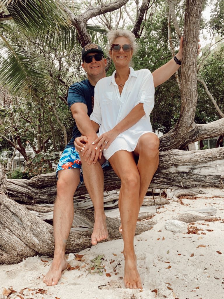 The Best Things to Do in Key Largo for Couples, a travel guide featured by top US travel blogger, She Gave It A Go | Things to do in Key Largo by popular Alabama travel blog, She Gave It A Go: image of a couple sitting together at the beach. 