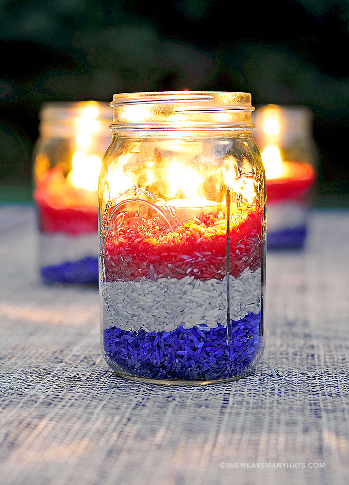 DIY Memorial Day Table Decorations featured by top AL home and lifestyle blogger, She Gave It A Go |Memorial Day Table Top Decorations by popular Alabama DIY blog, She Gave It A Go: image of mason jars filled with red, white, and blue rice and tea light candles.