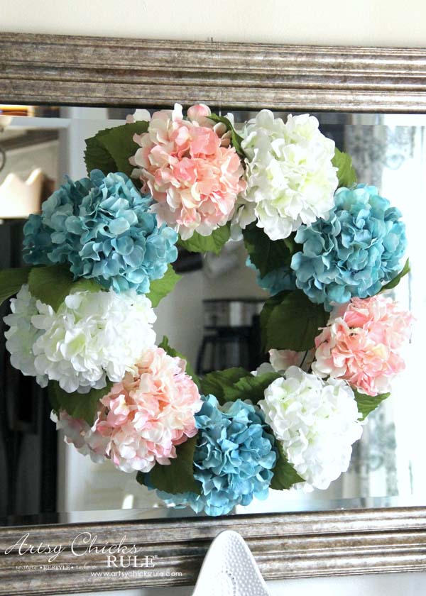 7 Rustic Farmhouse Wreath Ideas for your Summer Front Porch featured by top AL home blogger, She Gave It A Go | Farmhouse Wreath Ideas by popular Alabama life and style blog, She Gave It A Go: image of a faux white, blue and pink hydrangea wreath. 
