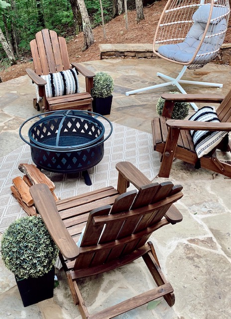 July 4th Edition Of Welcome Home Saturday by top AL home blogger, She Gave It A Go | Welcome Home Saturday by popular Alabama lifestyle blog, She Gave It A Go: image of a back patio with boxwood topiary plants in black planters, wooden chairs, egg chair, and black metal fire pit. 