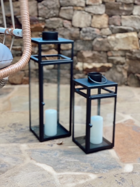 Family Patio Ideas for summer featured by top AL home blogger, She Gave It A Go |  Family Patio Ideas by popular Alabama life and style blog, She Gave It A Go: image of two black metal lanterns with white pillar candles. 