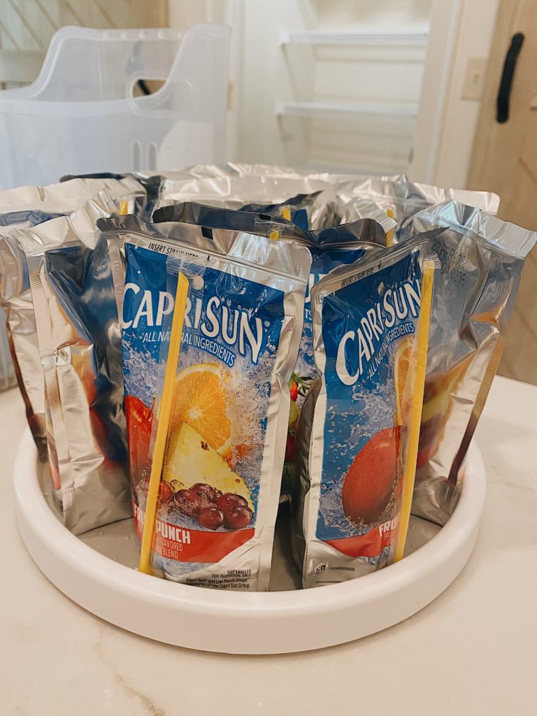 21 Summer Pantry Staples your Family Needs featured by top AL lifestyle blogger, She Gave It A Go | Pantry Items by popular Alabama lifestyle blog, She Gave It A Go: image of CapriSun drinks on a white Lazy Susan. 