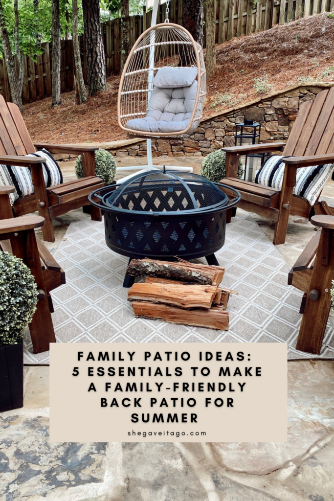 Family Patio Ideas for summer featured by top AL home blogger, She Gave It A Go | Family Patio Ideas by popular Alabama life and style blog, She Gave It A Go: image of a patio with a black metal fire pit, wooden chairs, potted topiary plants, and a hanging rattan chair.