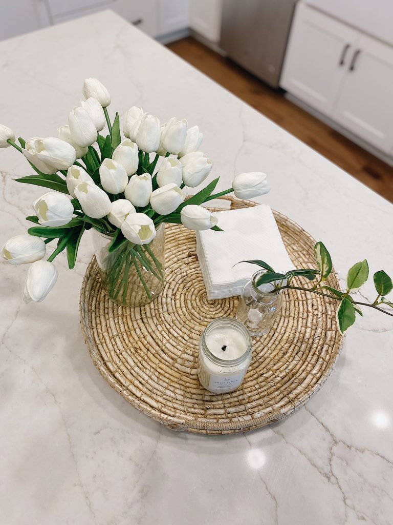 Summer Home Tour 2021: Kitchen, Bathroom, And Teen Girls Room ideas featured by top AL home blogger, She Gave It A Go. | Summer Home Tour by popular Alabama life and style blog, She Gave It A Go: image of a vase of faux white tulips resting a woven circular tray. 