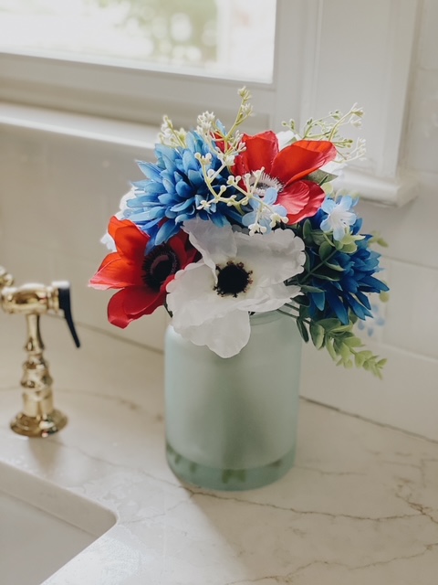 Patriotic Farmhouse Decor featured by top AL home blogger, She Gave It A Go | Patriotic Decor by popular Alabama life and style blog, She Gave It A Go: image of faux red, white, and blue flowers in a frosted vase. 