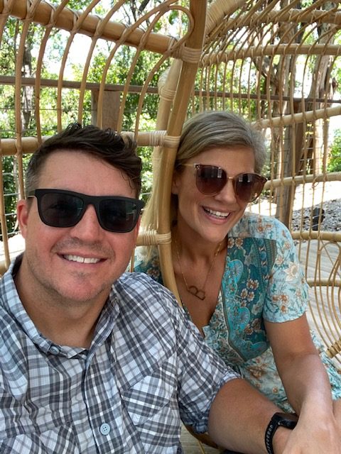 5 Essential Beach Vacation Tips for your Family featured by top AL family blogger, She Gave It a Go | Family Beach Vacation by popular Alabama travel blog, She Gave It A Go: image of a man and woman sitting together outside in rattan chairs. 
