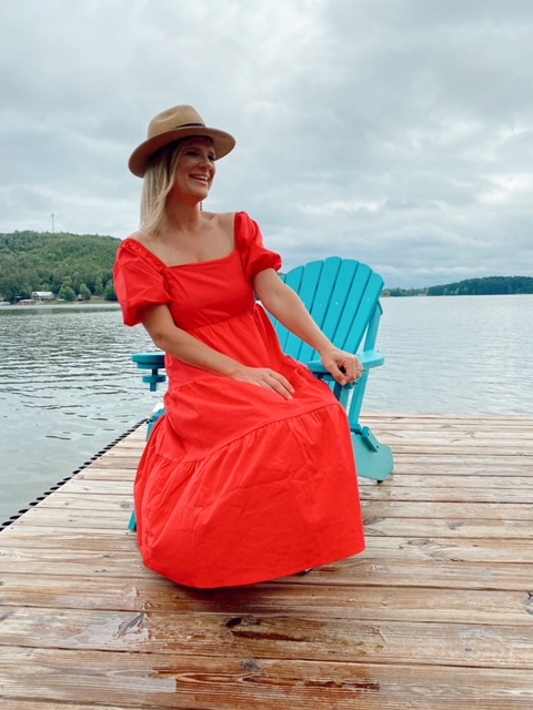 July 4th Edition Of Welcome Home Saturday by top AL home blogger, She Gave It A Go | Welcome Home Saturday by popular Alabama lifestyle blog, She Gave It A Go: image of a woman sitting in a blue wooden chair on a dock and wearing a red maxi dress with a straw fedora hat. 