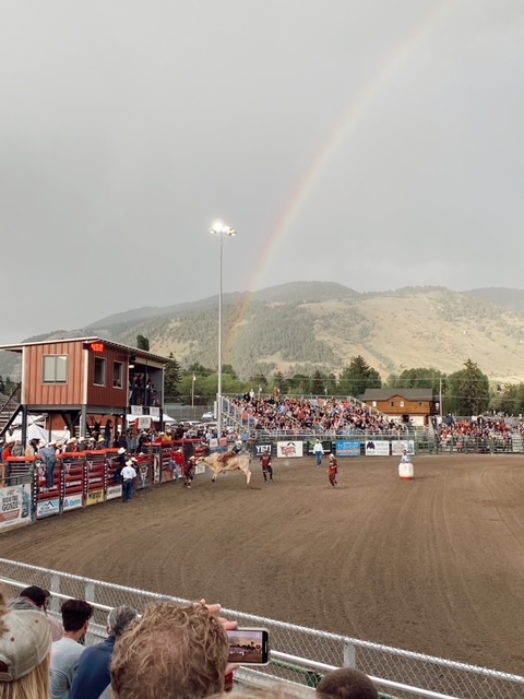 7 Best Things to Do in Jackson Hole with Teens featured by top AL family blogger, She Gave It A Go | Best Things to do in Jackson Hole by popular Alabama travel blog, She Gave it a Go: image of a rodeo and a rainbow in the background. 