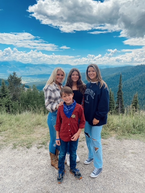 7 Best Things to Do in Jackson Hole with Teens featured by top AL family blogger, She Gave It A Go | Best Things to do in Jackson Hole by popular Alabama travel blog, She Gave it a Go: image of a mom and her three kids standing together in the mountains. 