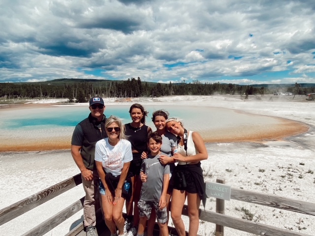 7 Best Things to Do in Jackson Hole with Teens featured by top AL family blogger, She Gave It A Go | Best Things to do in Jackson Hole by popular Alabama travel blog, She Gave it a Go: image of a family at Yellowstone National Park. 