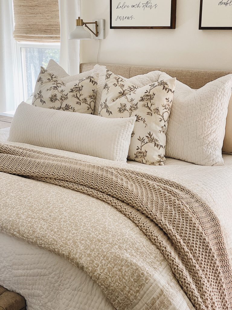 neutral master bed styling with lots of cozy layers