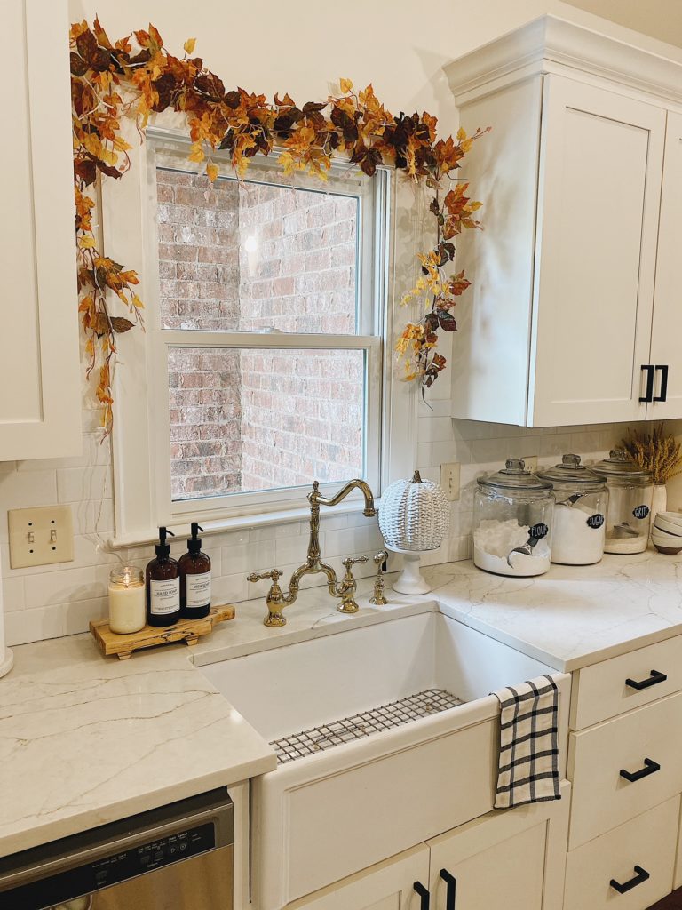 kitchen sink with fall garland above and farmhousestyle sink