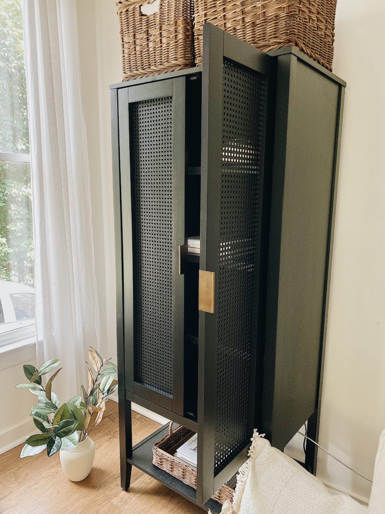 black cabinet with door open to show built-in storage