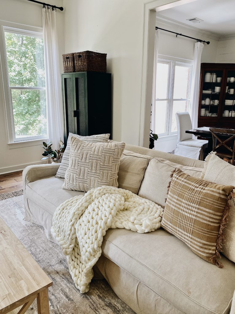 cozy living room with pillows and chunky blanket