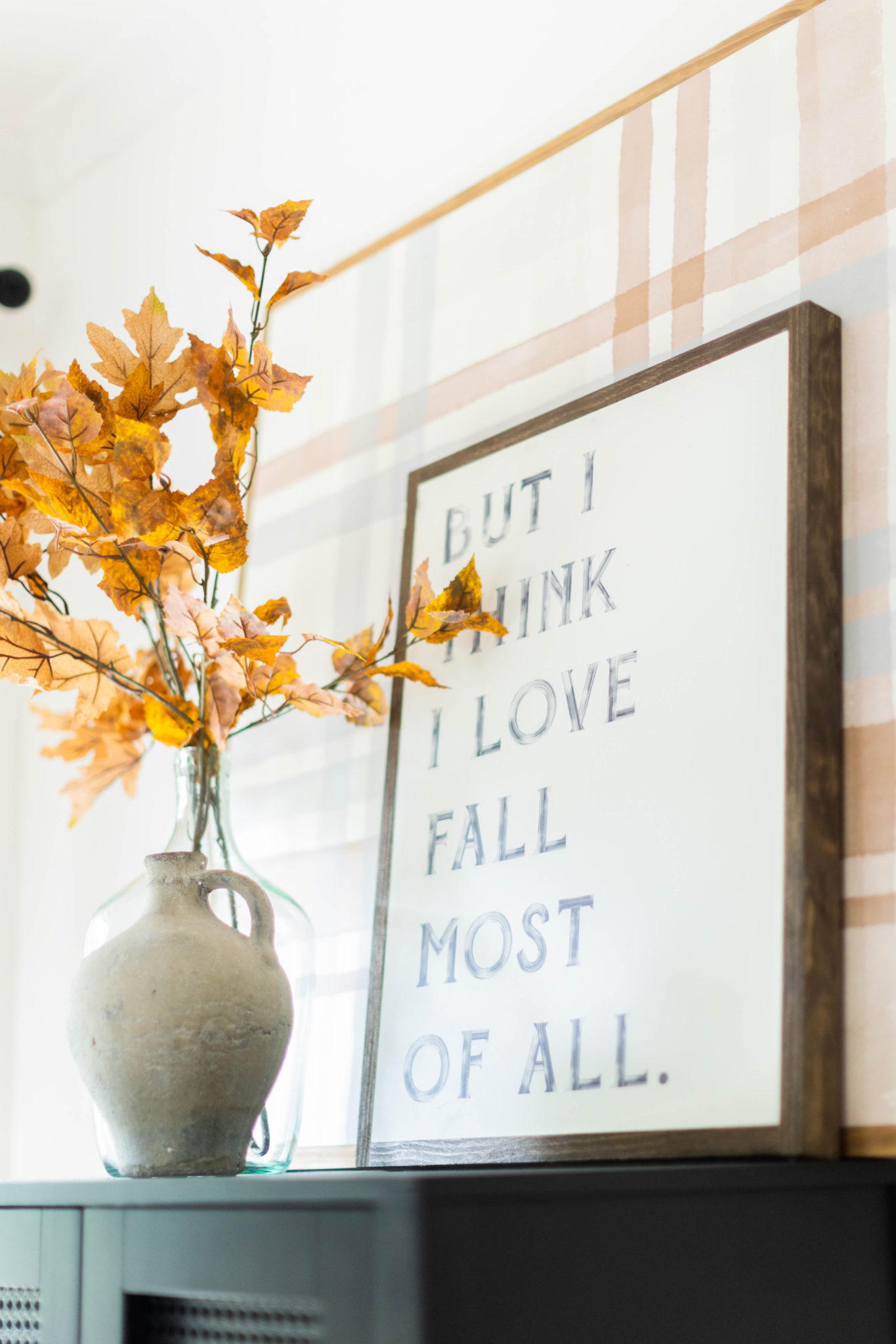 faux fall stems in a vase with wood signs