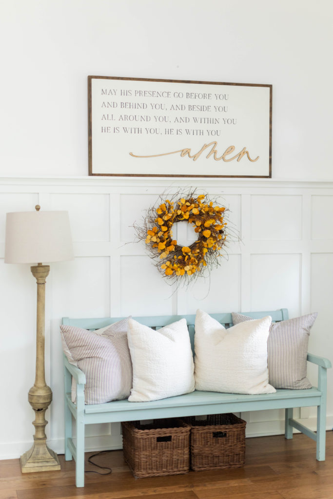 entryway with blue bench and fall wreath