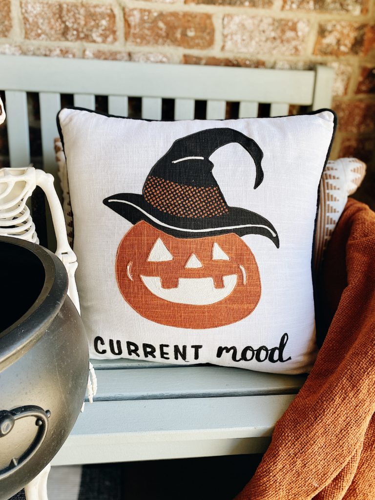 Halloween jack-o-lantern pillow on bench