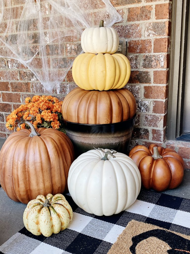pumpkin stack by front door with other pumpkins
