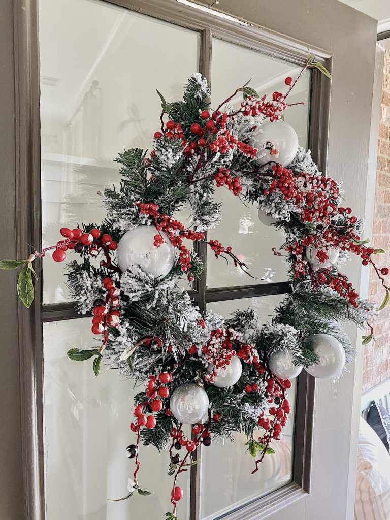 berry and pine wreath on front door