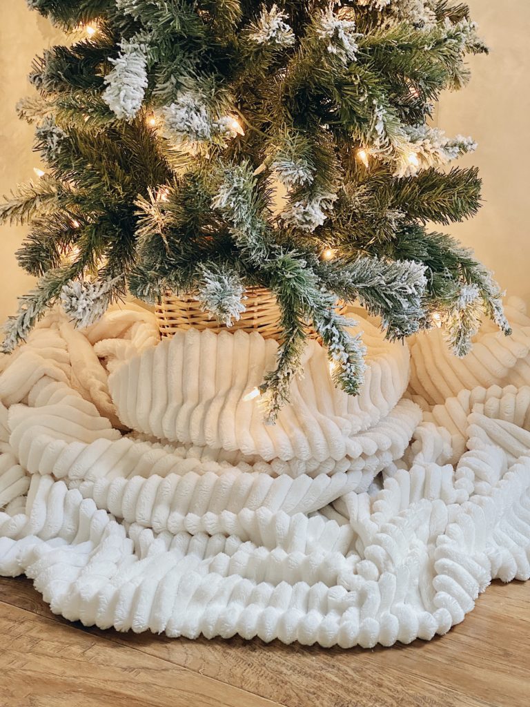 blanket wrapped around the base of a christmas tree