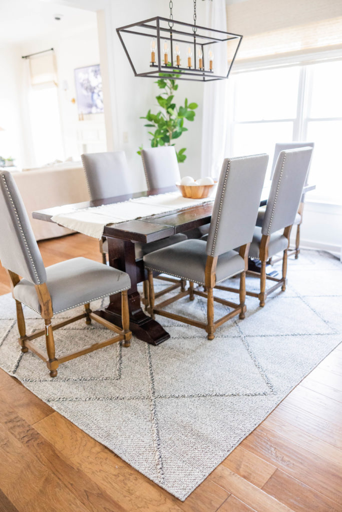 dining room with gray chairs and rug