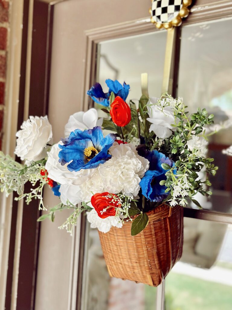 brown hanging basket with red, white and blue flowers
