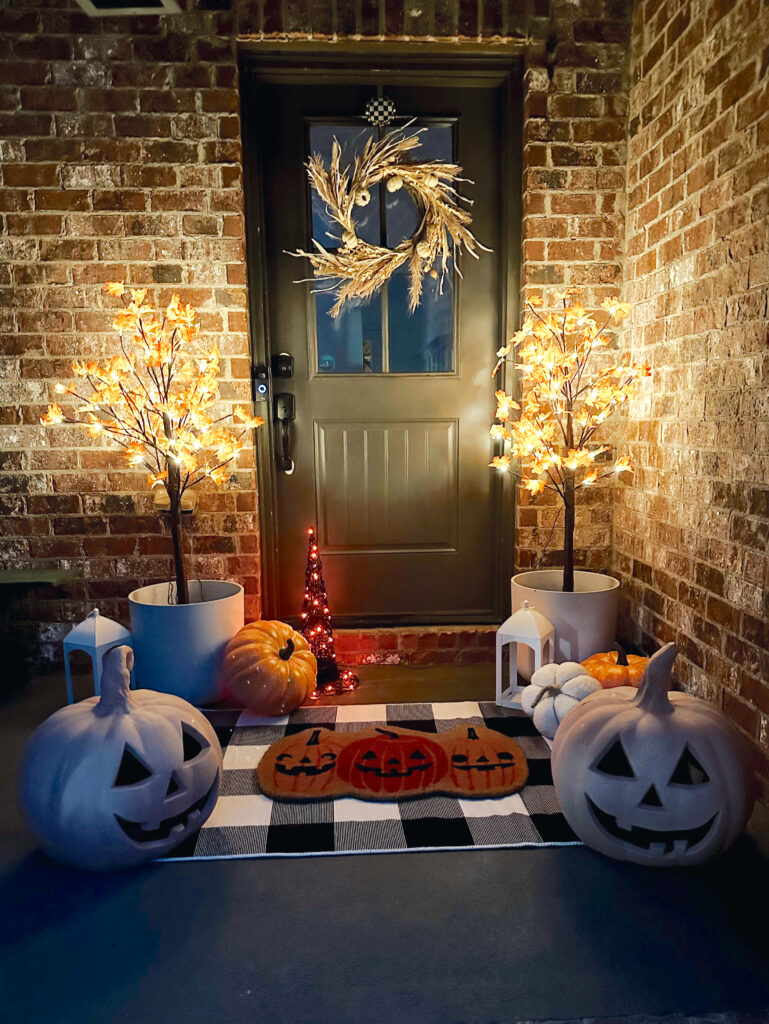 Nighttime view of Halloween porch with DIY terracotta pumpkins