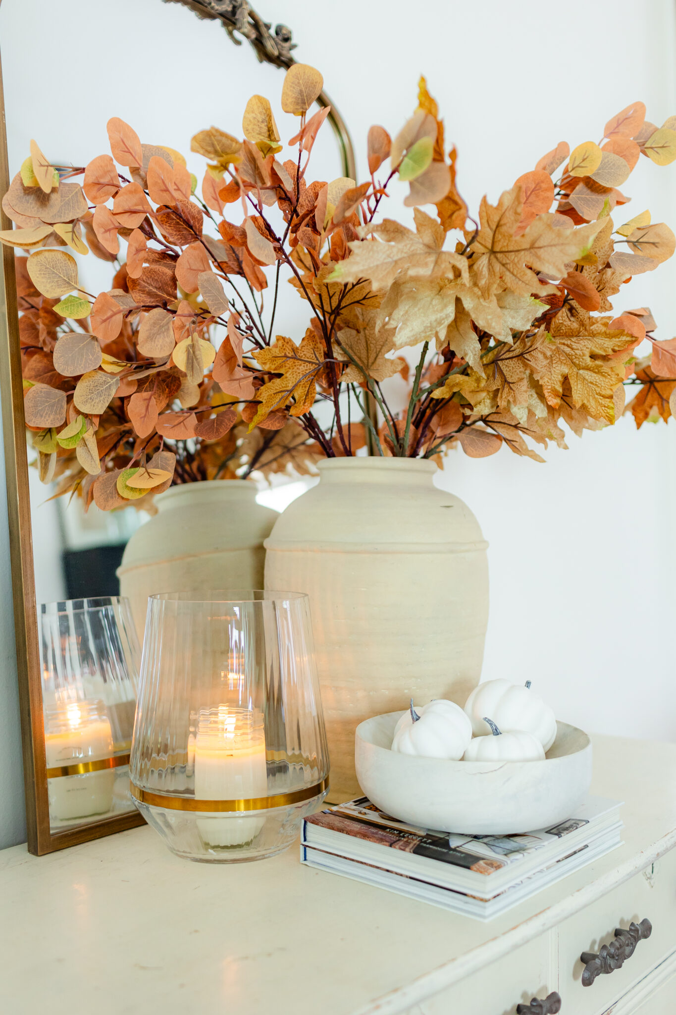 fall candle with large vase full of seasonal fall stems and pumpkins in a bowl for fall decorating idea!