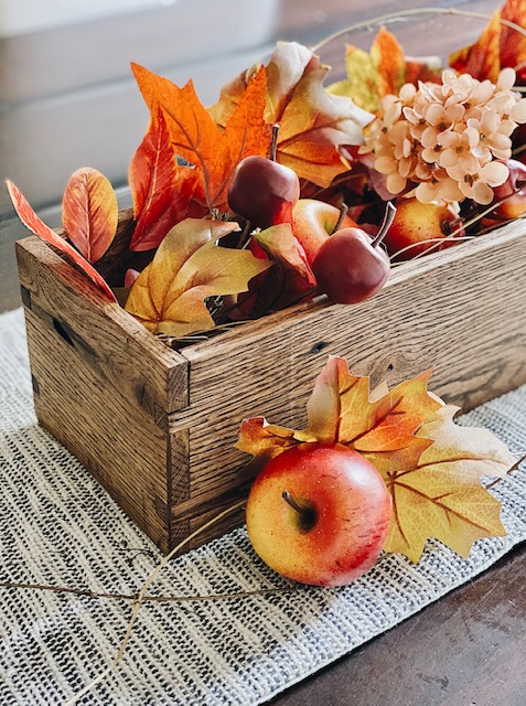 October home decor idea is this DIY rustic centerpiece box full of autumn fruits and leaves