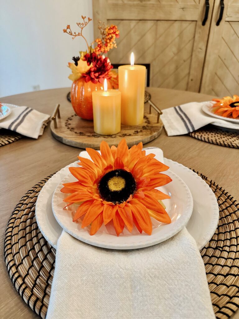 faux sunflower on white plates with napkins
