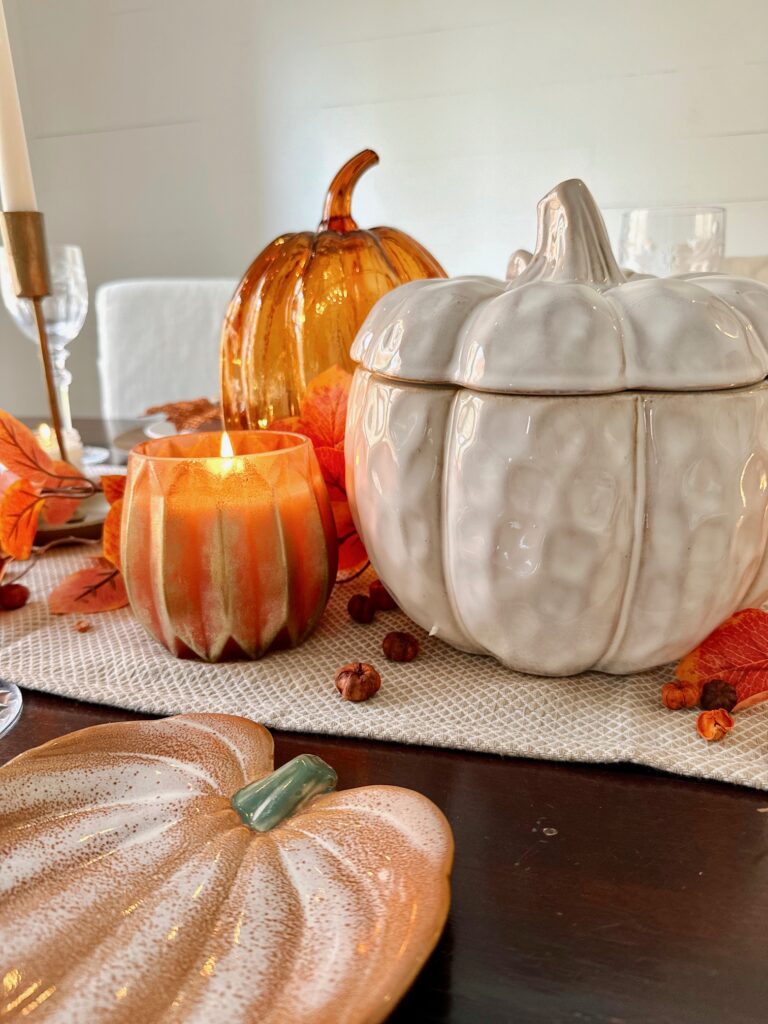 Thanksgiving centerpiece that includes ceramic and glass pumpkins