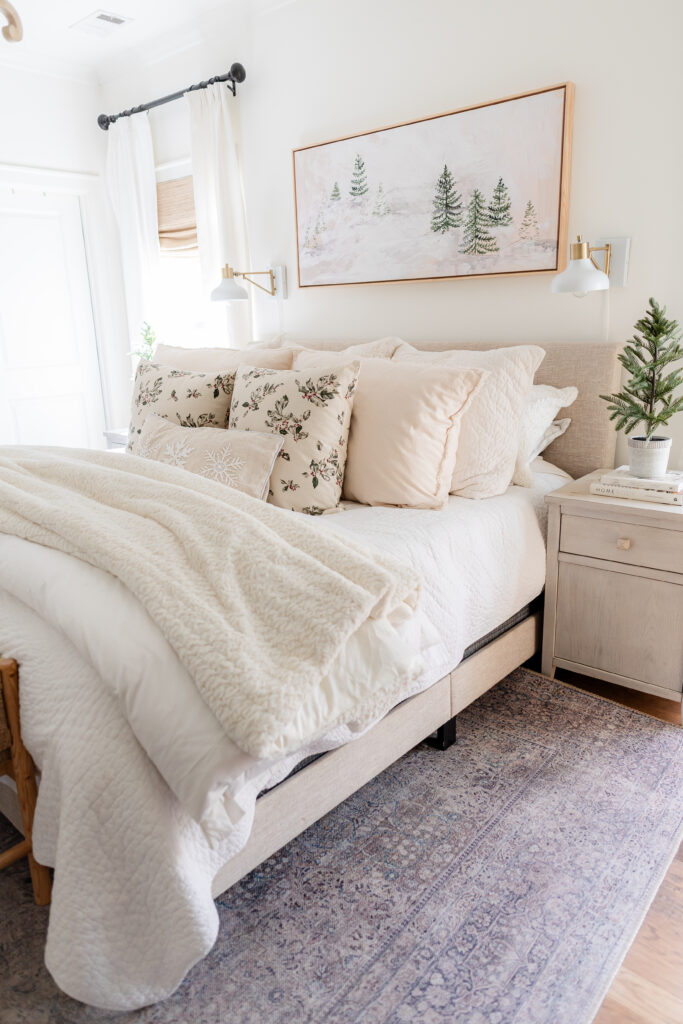 cozy holiday bliss in our 2023 bedroom with layers of textured white blankets and faux fur throws