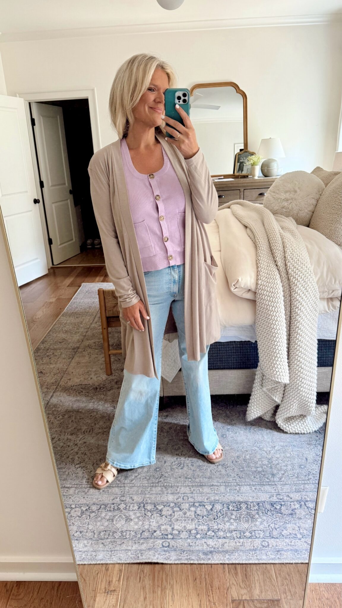 A chic, effortless outfit featuring a lavender sweater vest and cozy cardigan for a polished yet laid-back look.